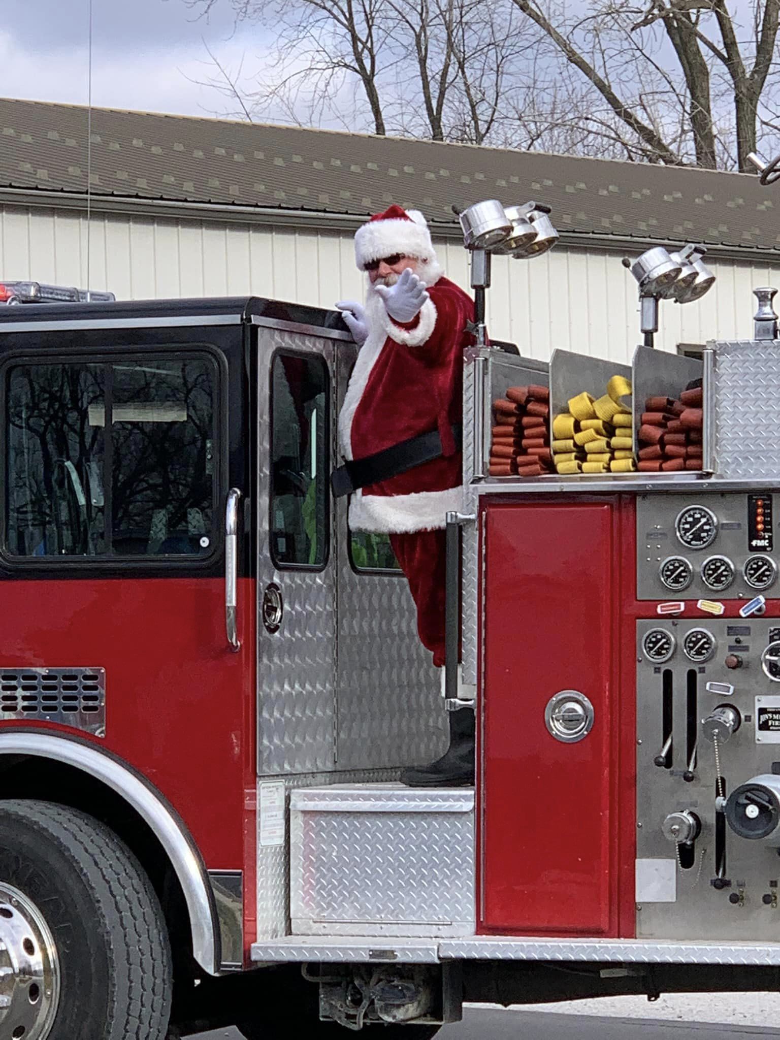 Santa Tom waving from a firetruck in the Auxvasse Christmas Parade