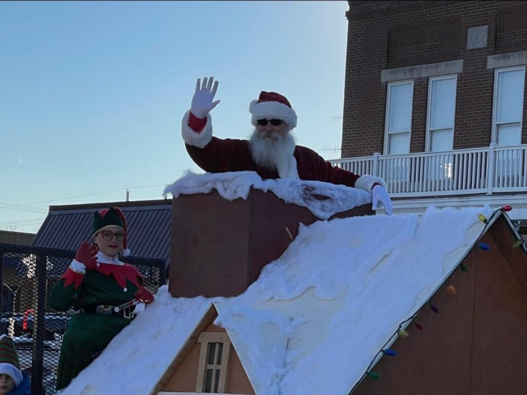 Santa Tom waving from a Christmas parade float in Central Missouri.
