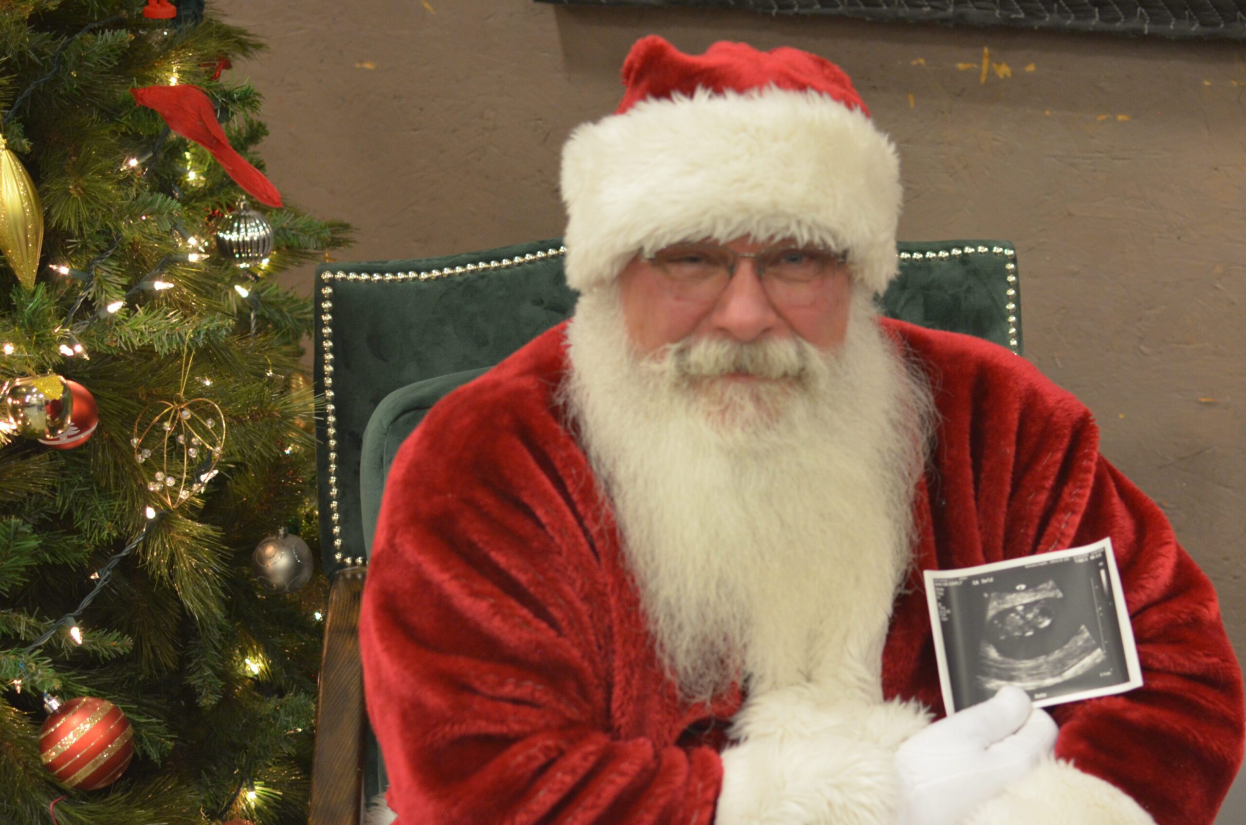 Santa Tom posing with the photo of a soon-to-be fan