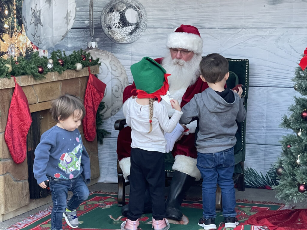 Santa Tom Chatting with Young Visitors