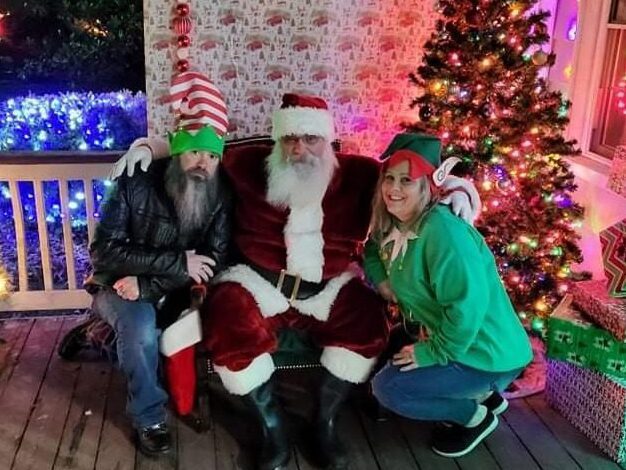 Santa Tom sharing Christmas cheer with holiday guests during a festive Central Missouri Christmas celebration.