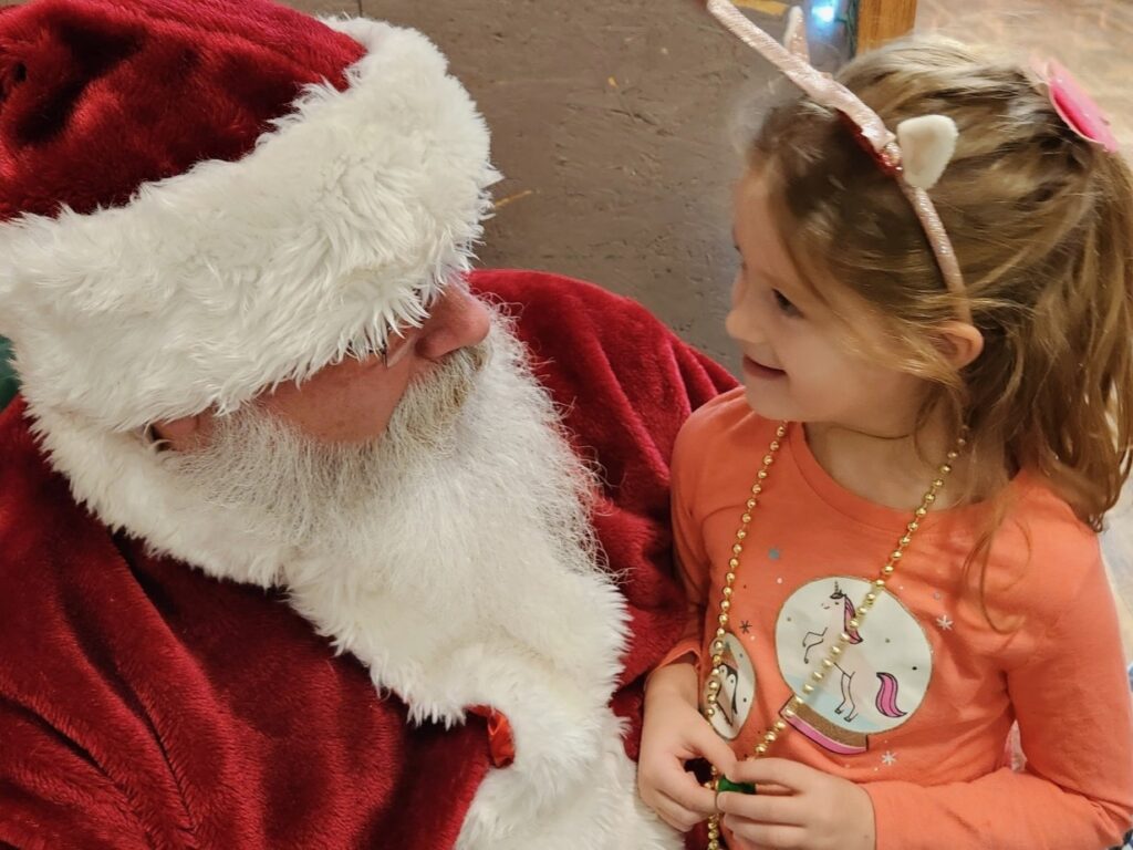 Santa Tom having a conversation with a young girl