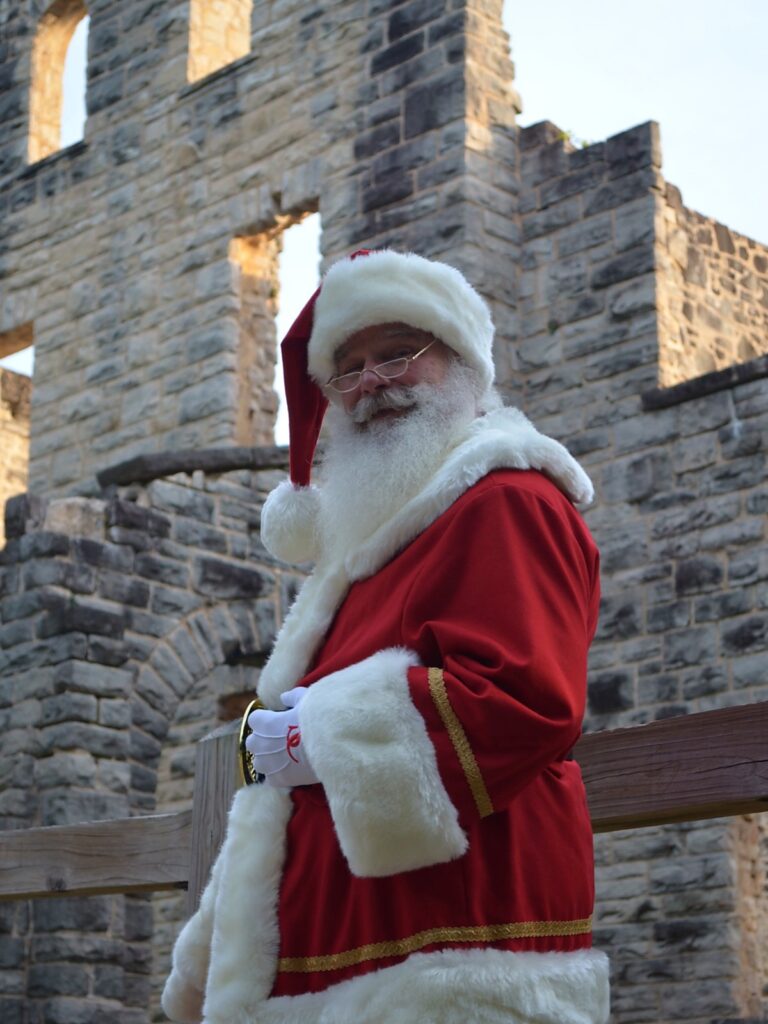 Santa Tom in a classic red Santa suit near Ha Ha Tonka ruins.