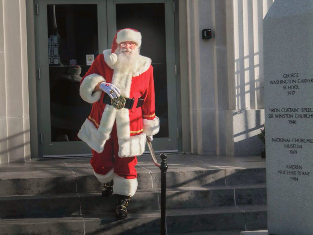 Santa Tom standing in a civic setting in downtown Fulton, Missouri.