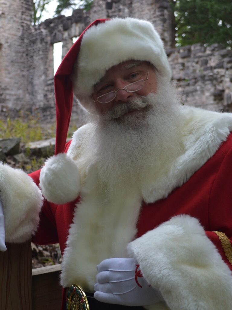 Santa Tom reaching toward the viewer near Ha Ha Tonka ruins in the Lake of the Ozarks area.