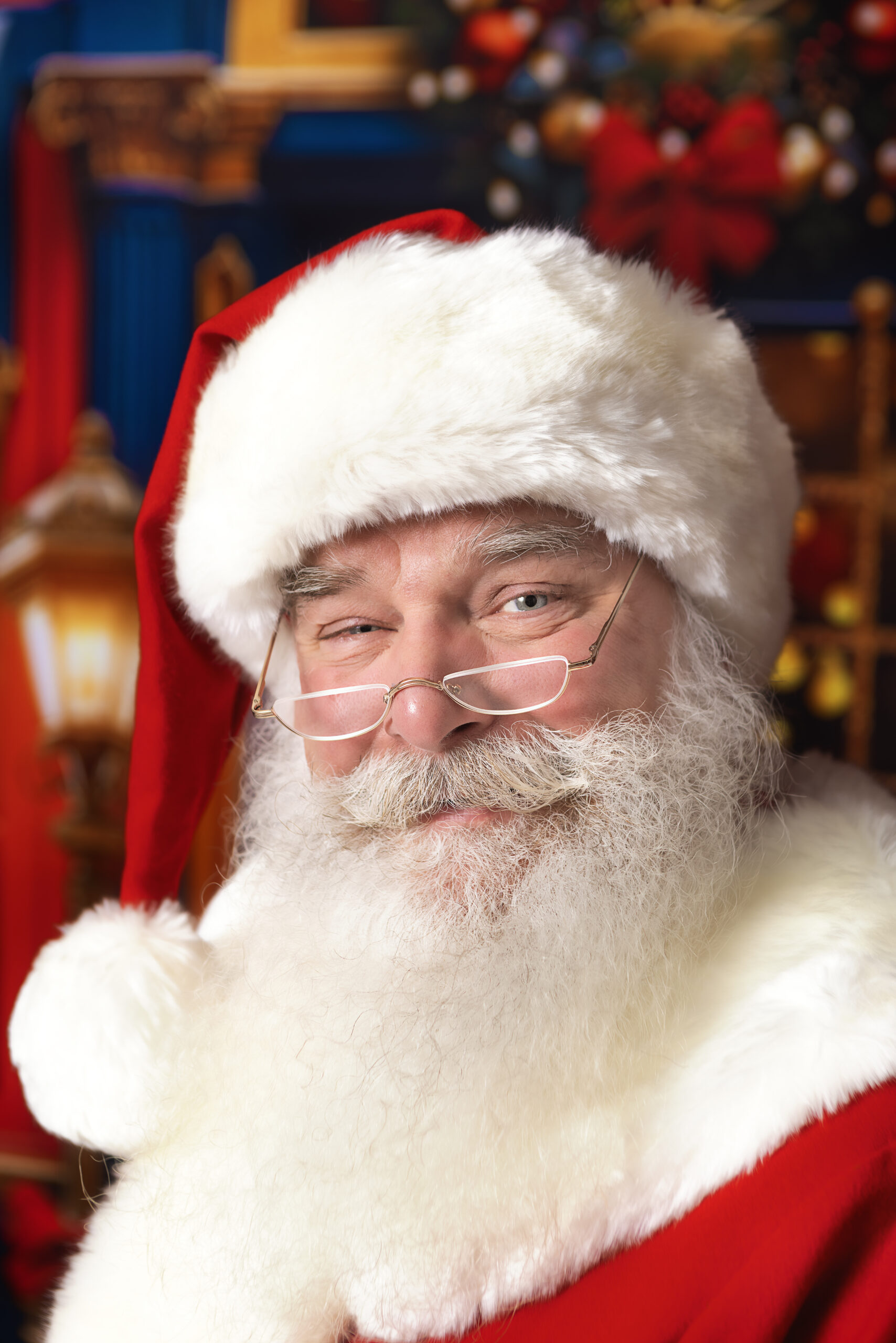 Close-up portrait of Santa Tom smiling in his Santa hat and glasses
